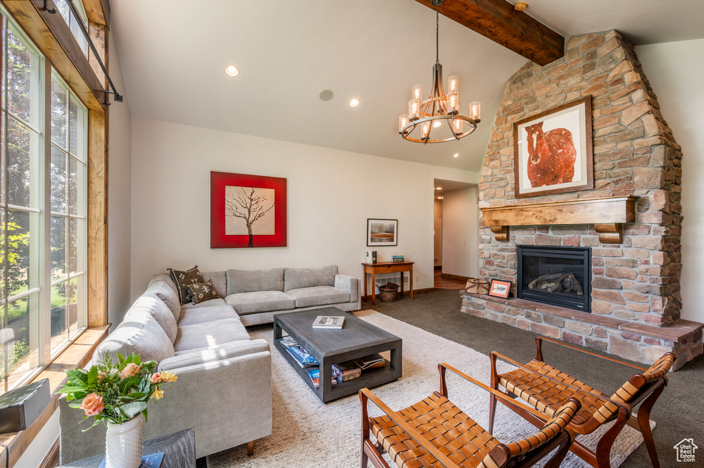 Living room featuring plenty of natural light, carpet flooring, and a stone fireplace