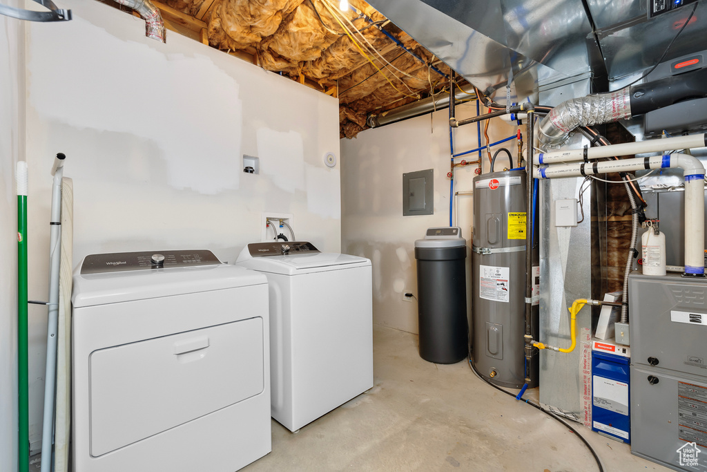 Laundry area with water heater, washing machine and dryer, and washer hookup