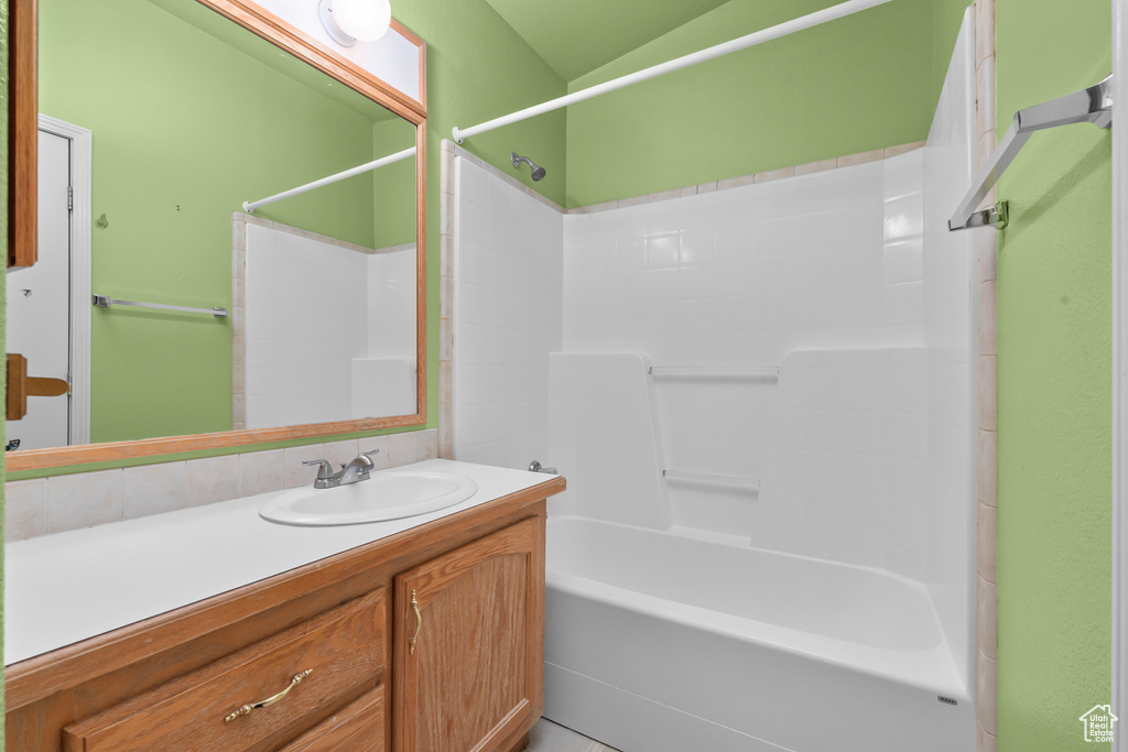 Bathroom featuring oversized vanity and shower / washtub combination