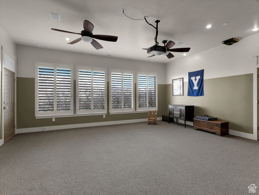 Interior space with ceiling fan and light carpet