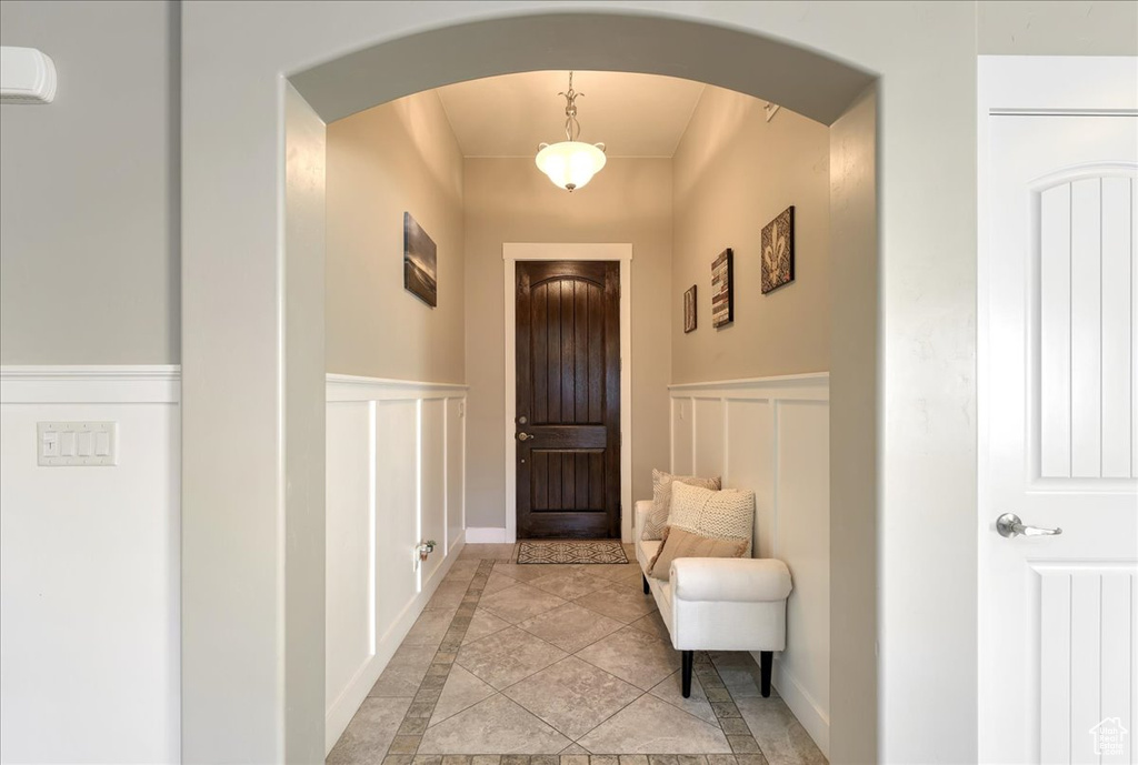Doorway to outside with light tile floors