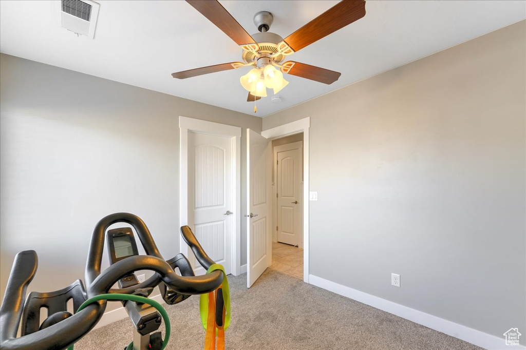 Interior space with light colored carpet and ceiling fan
