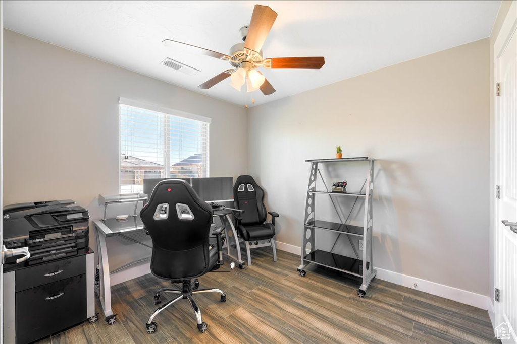 Office space with ceiling fan and dark hardwood / wood-style floors