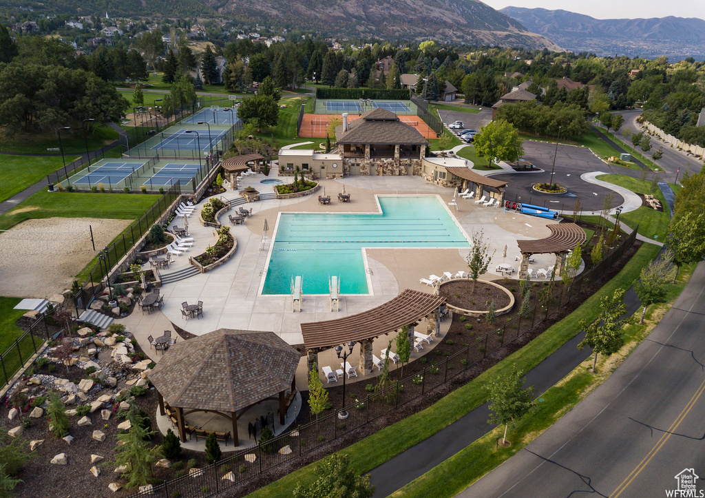 View of swimming pool featuring a patio, a mountain view, and a gazebo