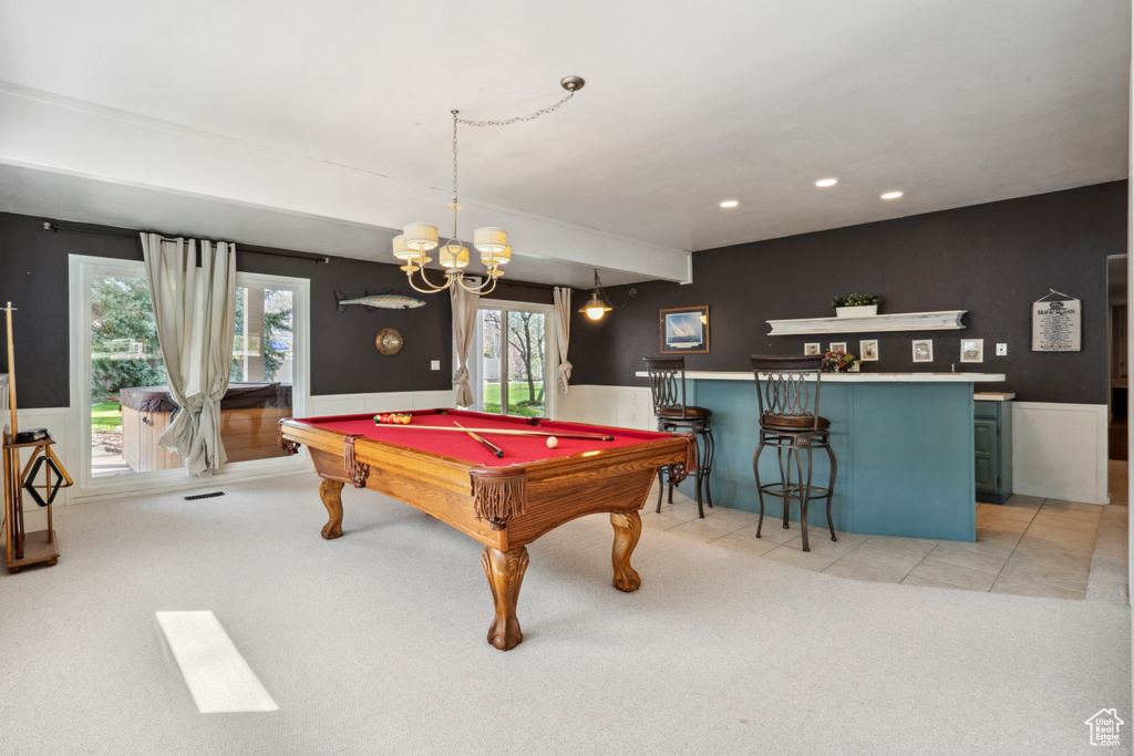 Game room with billiards, bar, and light carpet