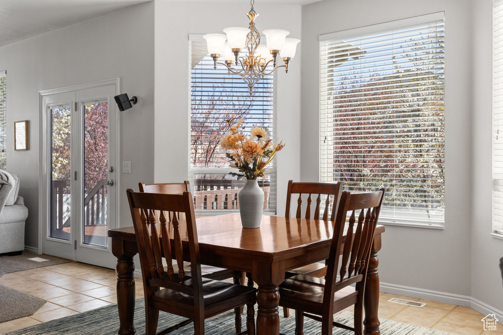 Dining room featuring an inviting chandelier and light tile flooring