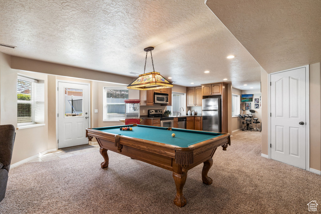 Playroom with a textured ceiling, billiards, light carpet, and sink