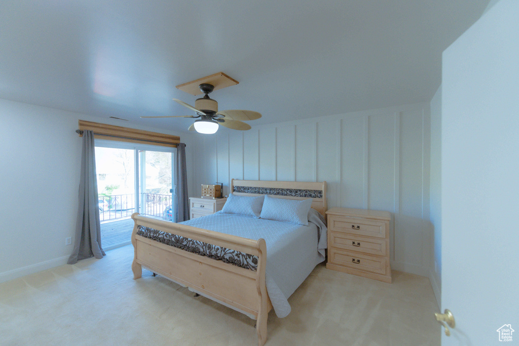 Carpeted bedroom featuring ceiling fan and access to outside