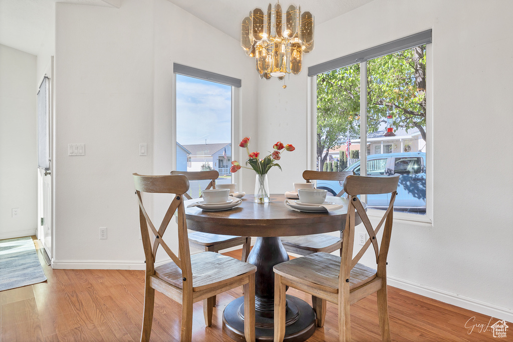 Dining space featuring light hardwood / wood-style floors and an inviting chandelier