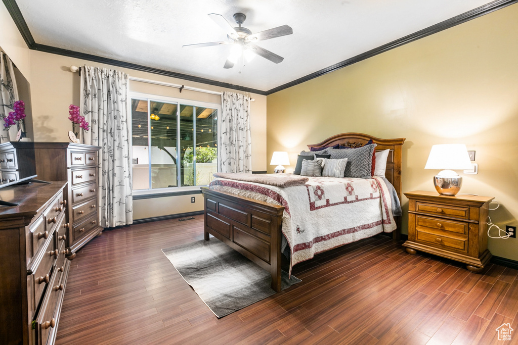 Bedroom featuring ceiling fan, crown molding, and dark hardwood / wood-style floors