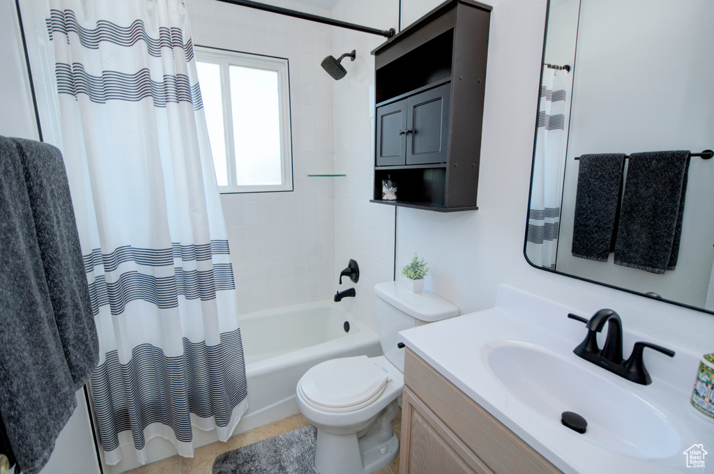 Full bathroom with vanity, toilet, and shower / tub combo with curtain
