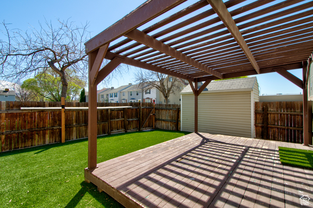 Deck featuring a yard and a pergola