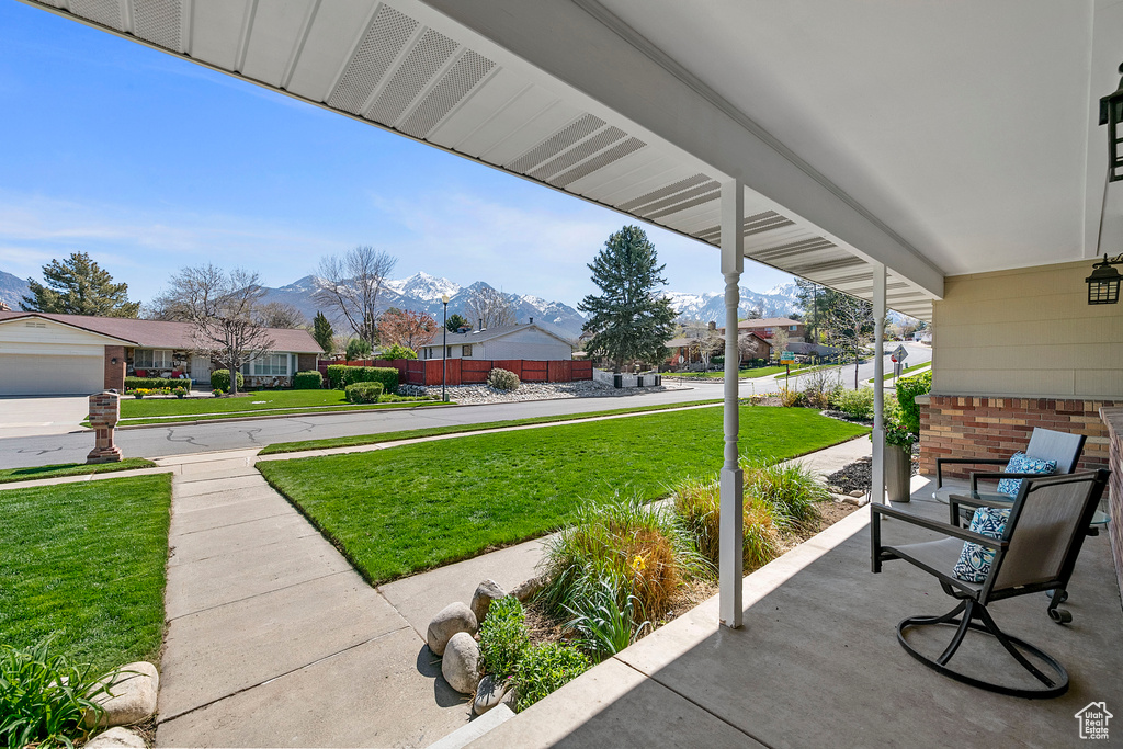 View of patio with a mountain view and a garage