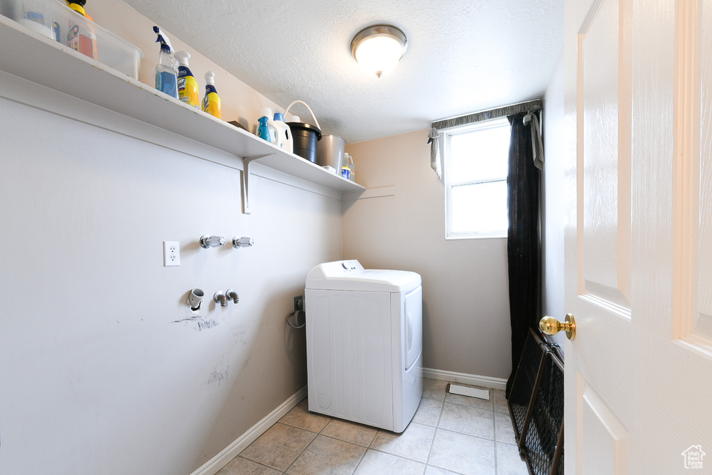 Laundry room featuring washer / dryer and light tile flooring