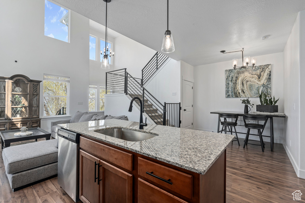 Kitchen featuring sink, an inviting chandelier, dark hardwood / wood-style floors, and stainless steel dishwasher