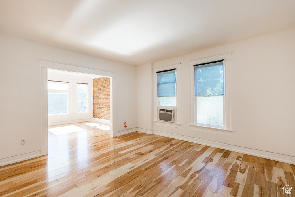 Unfurnished room featuring plenty of natural light and light hardwood / wood-style flooring