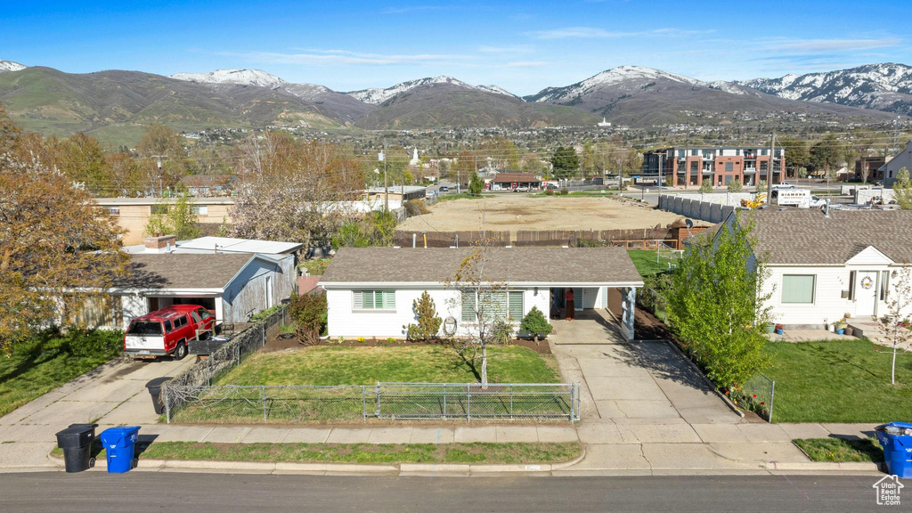 View of front of property featuring a mountain view and a front yard