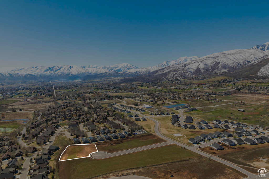Aerial view of property's location featuring a mountain backdrop and nearby suburban area