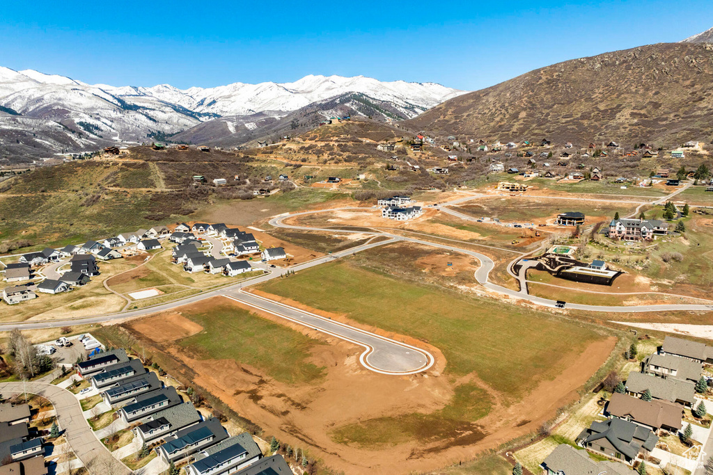 Aerial view of property's location featuring mountains and nearby suburban area