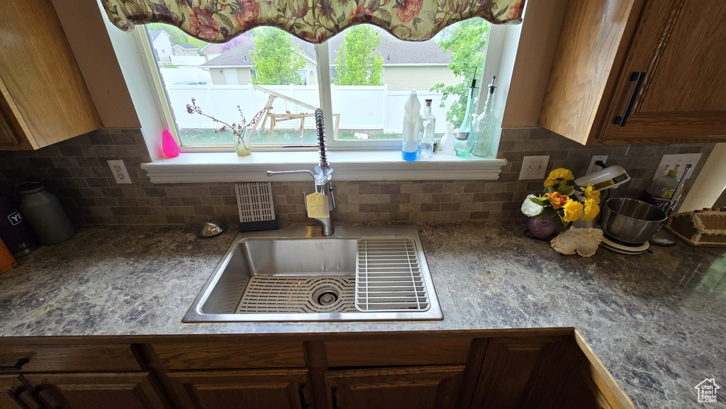 Kitchen featuring backsplash and sink