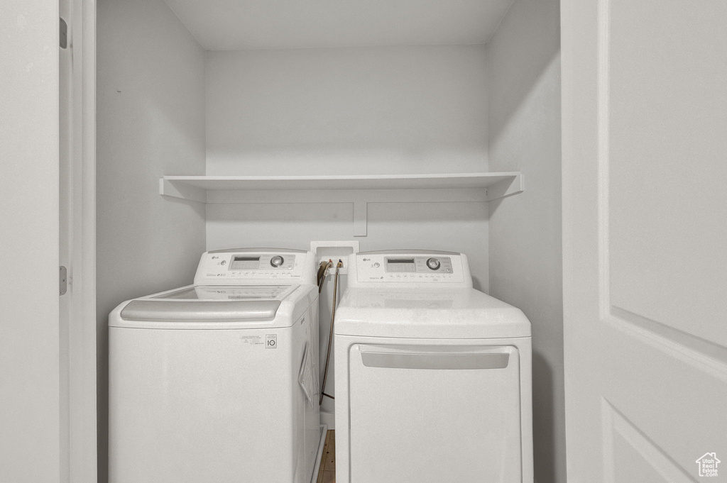 Laundry room with hookup for a washing machine and washing machine and clothes dryer