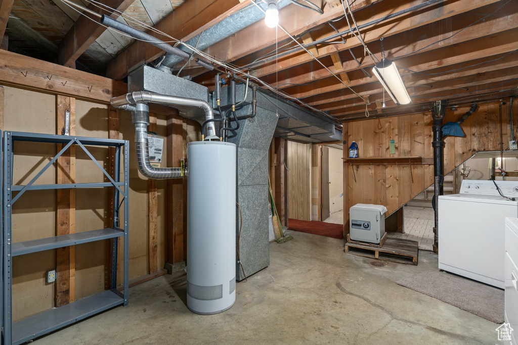 Basement featuring washer and clothes dryer and gas water heater