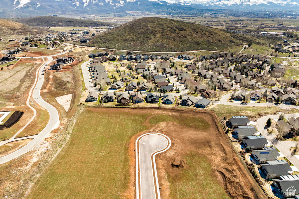 Aerial overview of property's location with nearby suburban area and mountains