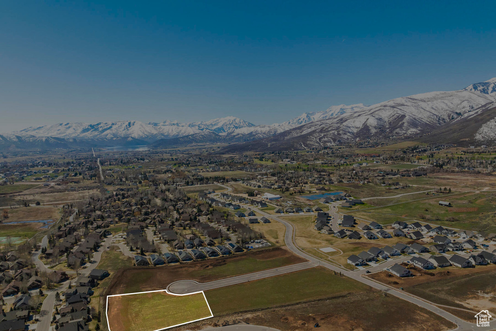 Aerial view of property's location featuring mountains and nearby suburban area