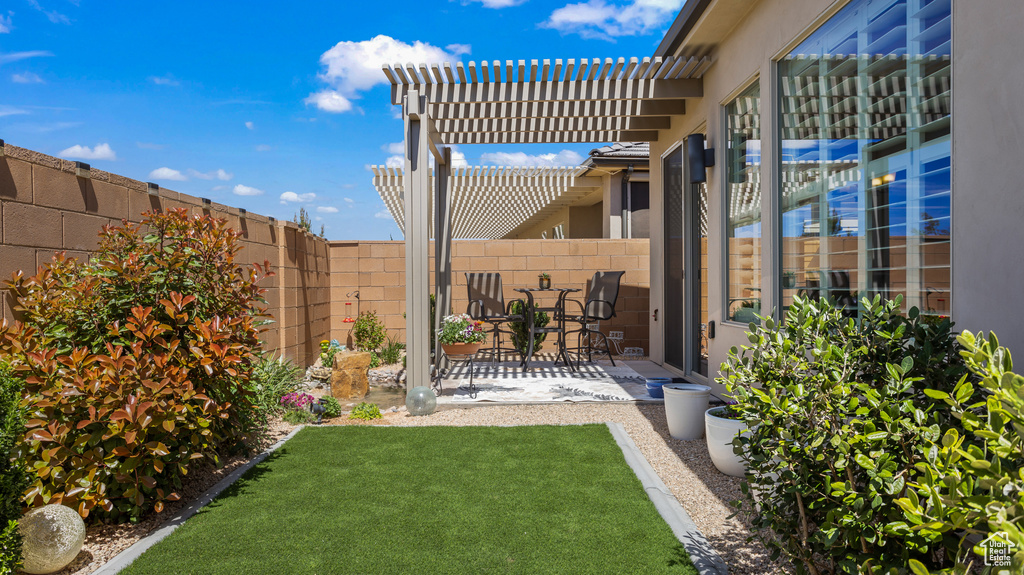 View of yard with a patio and a pergola