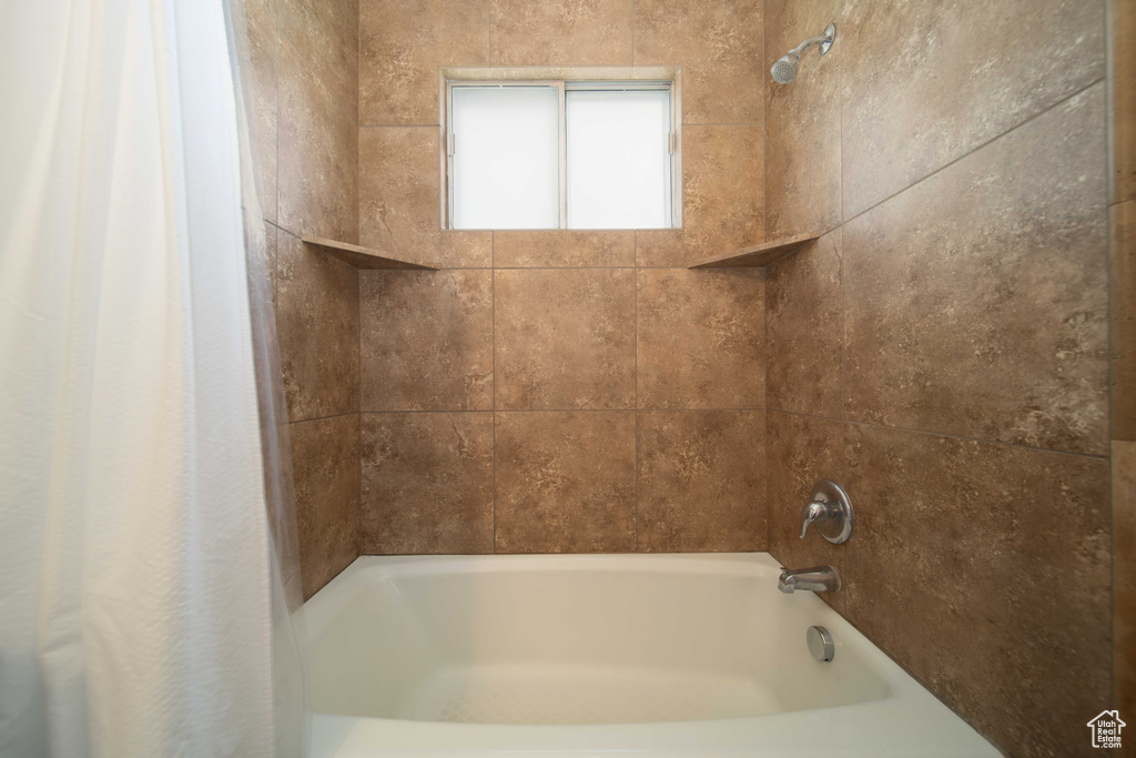 Bathroom featuring shower / tub combo with curtain