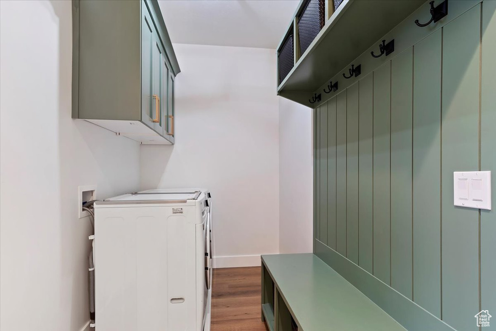 Mudroom with washing machine and dryer and hardwood / wood-style flooring