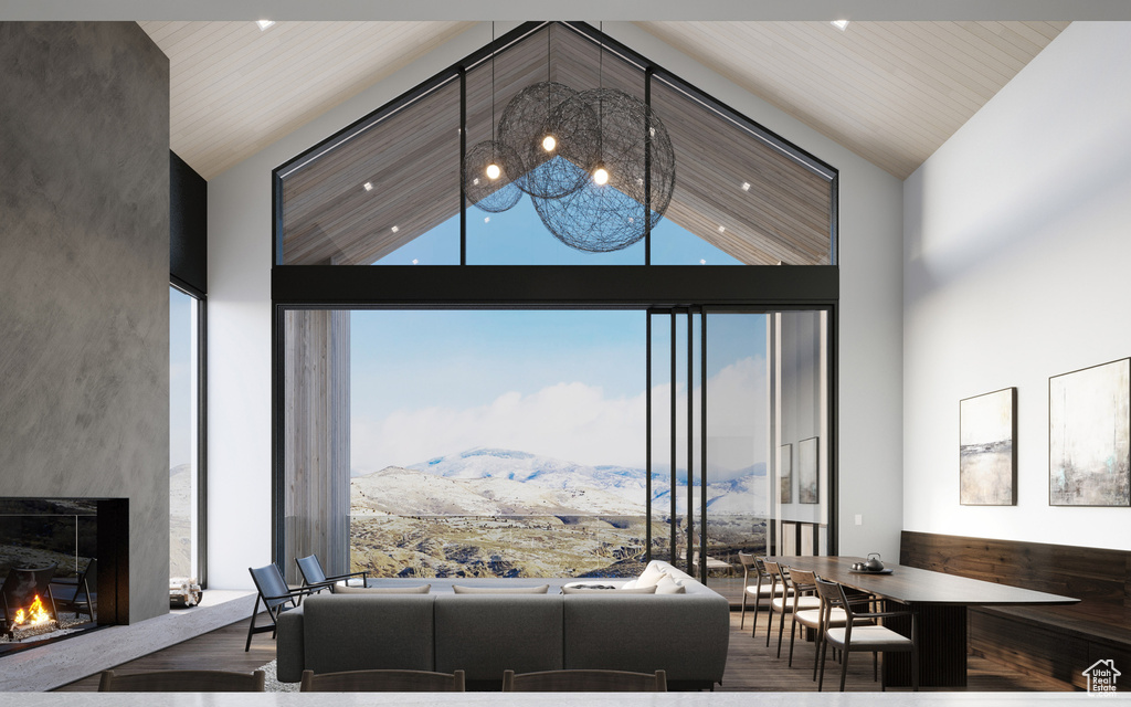 Living room with dark hardwood / wood-style flooring, a mountain view, a towering ceiling, and a premium fireplace