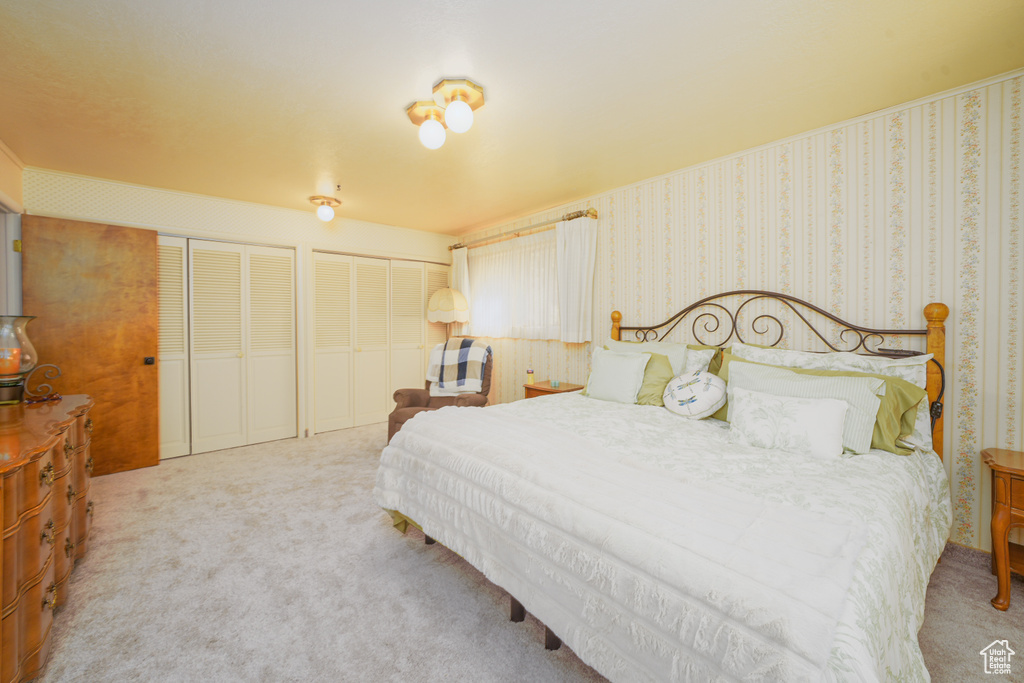 Carpeted bedroom with multiple closets