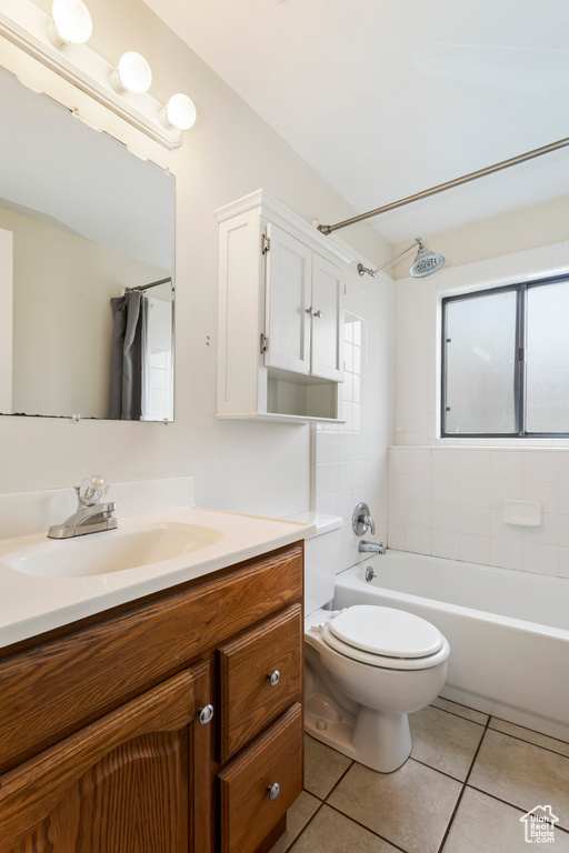 Full bathroom featuring large vanity, shower / bath combo, toilet, and tile flooring