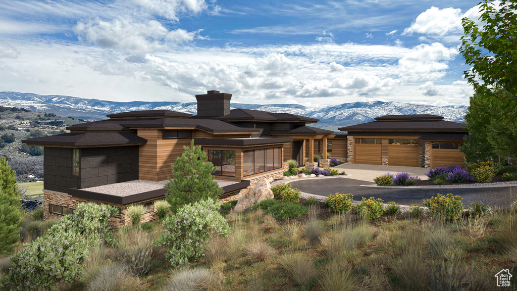 Prairie-style home with a mountain view and a garage