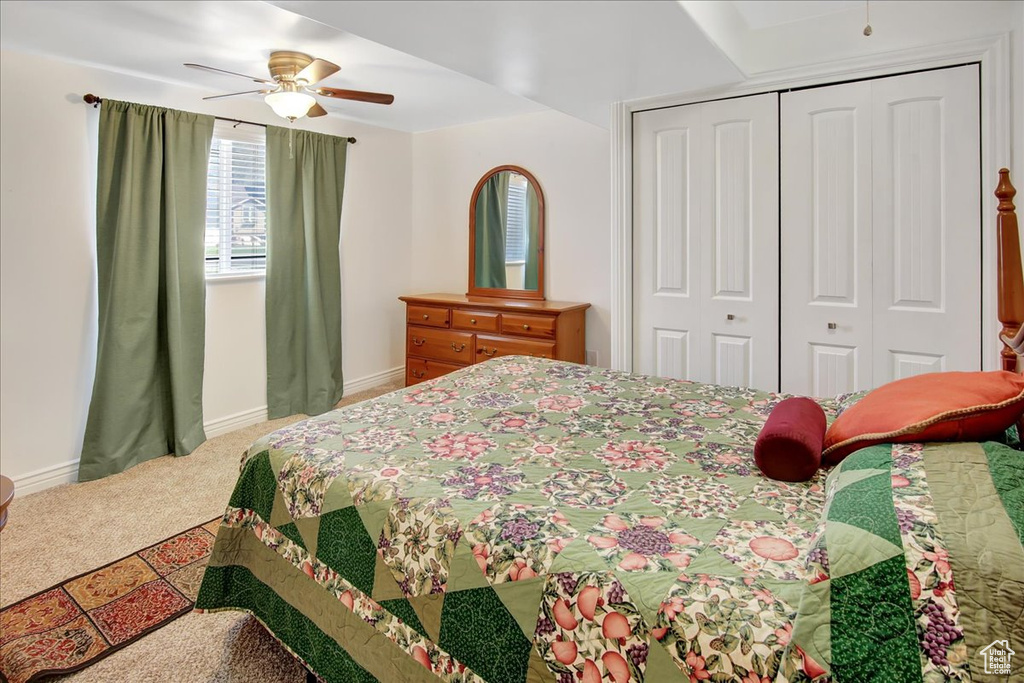 Bedroom featuring a closet, ceiling fan, and carpet floors