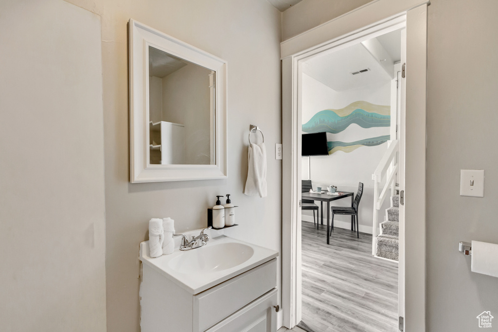 Bathroom with hardwood / wood-style flooring and vanity