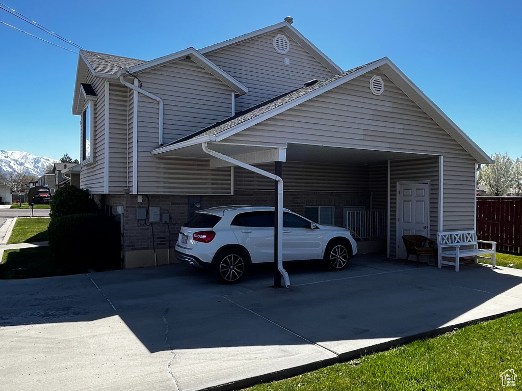 View of side of home with a carport