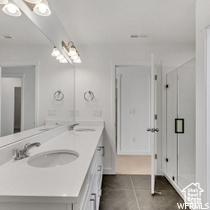 Bathroom featuring vanity and tile floors