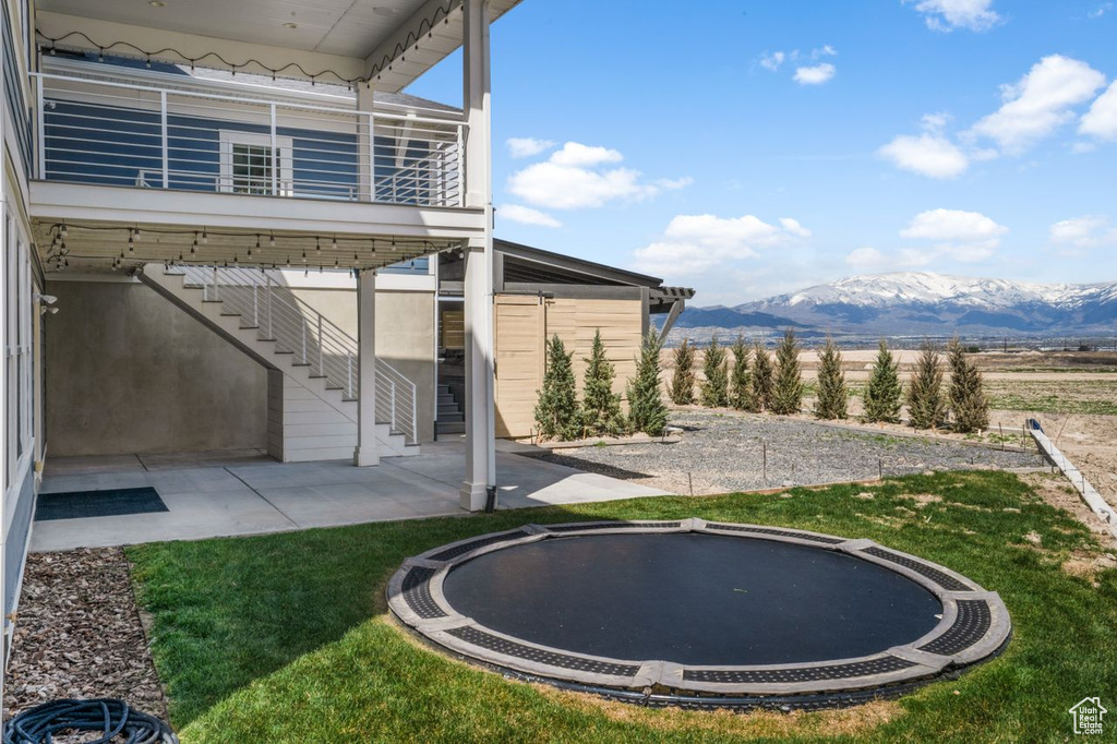 View of yard featuring a mountain view and a trampoline