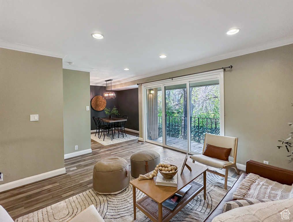 Living room featuring dark hardwood / wood-style flooring and ornamental molding