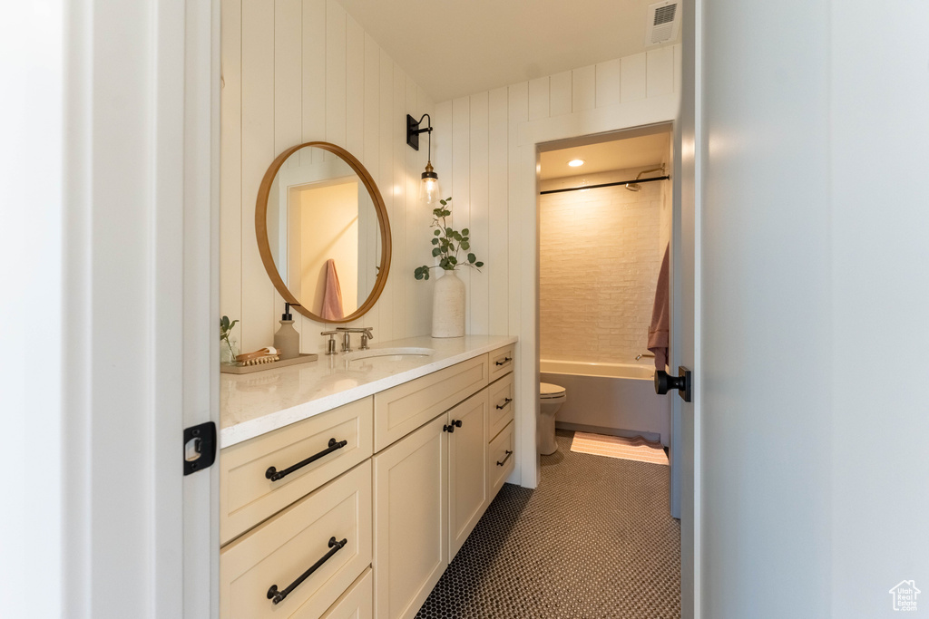 Full bathroom with shower / washtub combination, vanity, and toilet