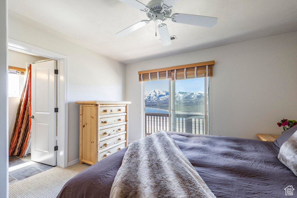 Tiled bedroom with ceiling fan and access to outside