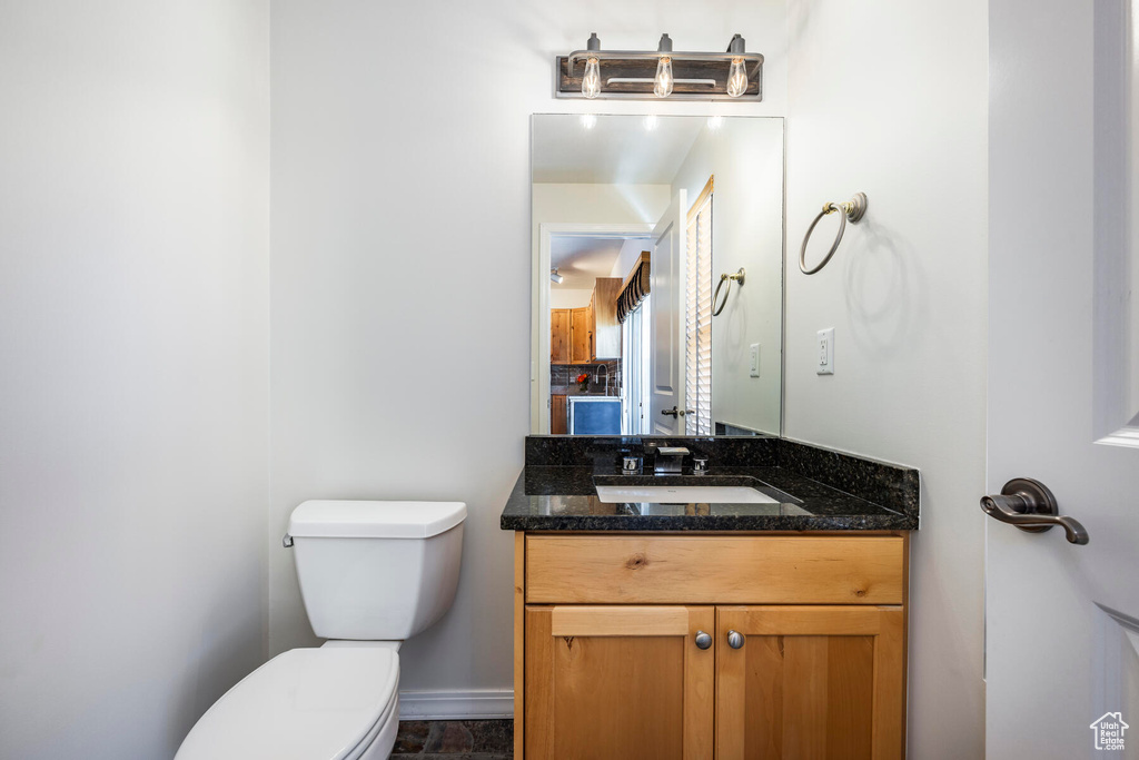 Bathroom featuring oversized vanity, tile floors, and toilet