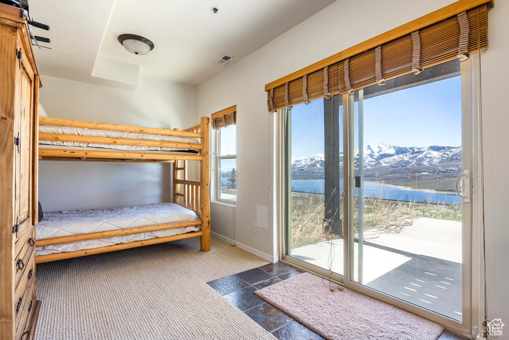 Unfurnished bedroom featuring a mountain view and access to exterior