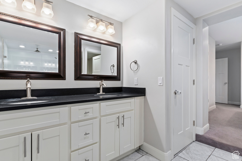 Bathroom with tile flooring and double vanity