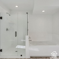 Bathroom featuring shower with separate bathtub