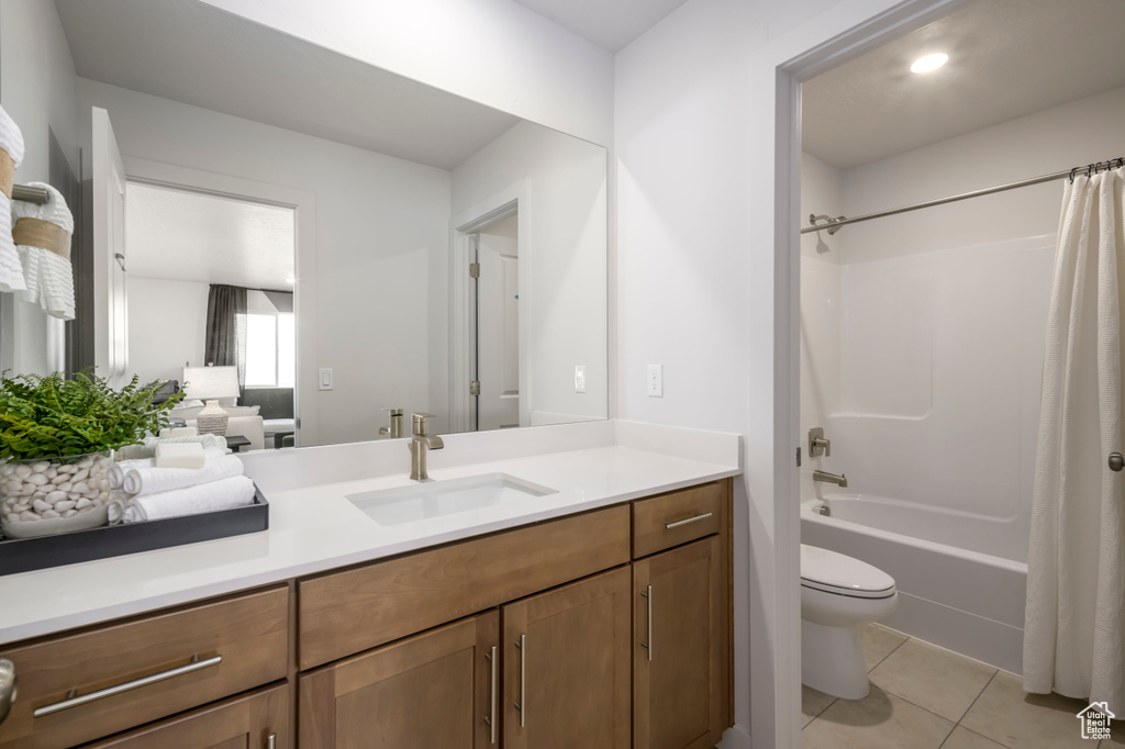 Full bathroom with toilet, vanity, shower / bath combo, and tile floors