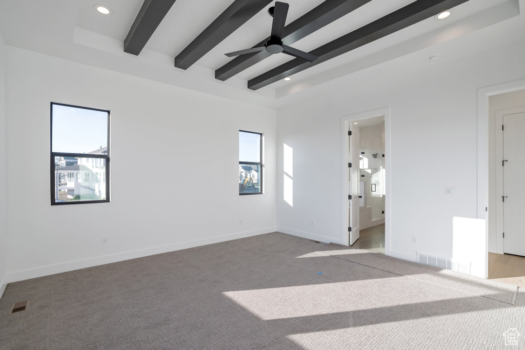 Carpeted spare room with beamed ceiling and ceiling fan