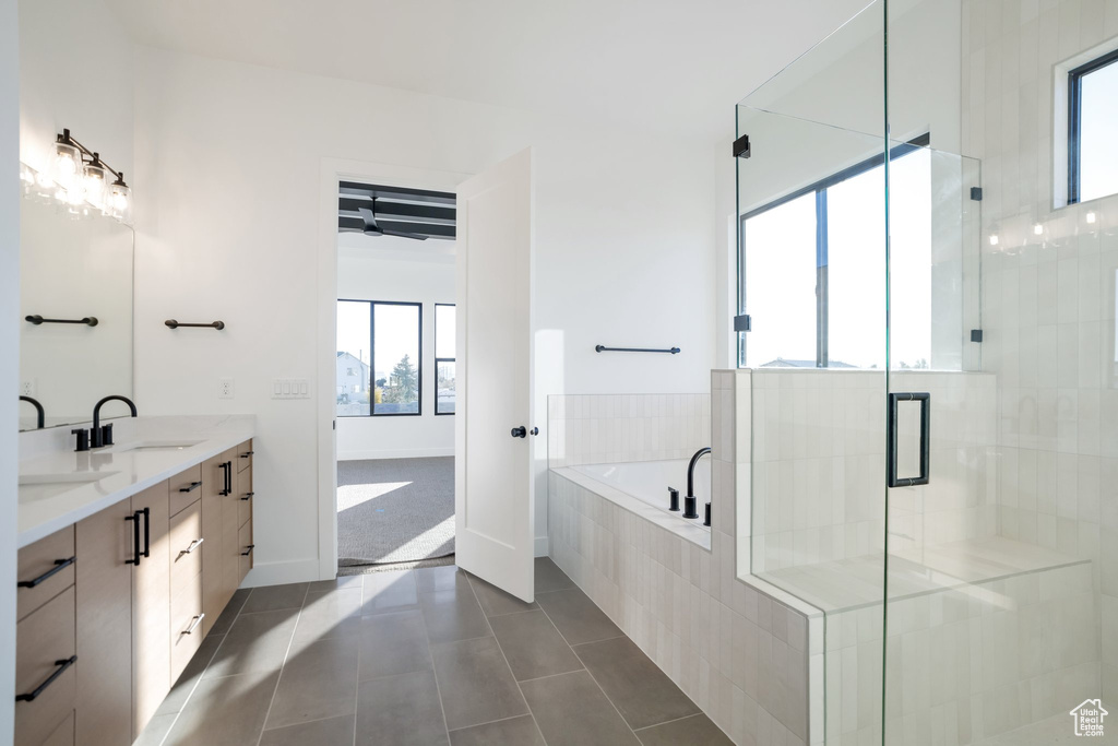 Bathroom with separate shower and tub, dual bowl vanity, and tile flooring